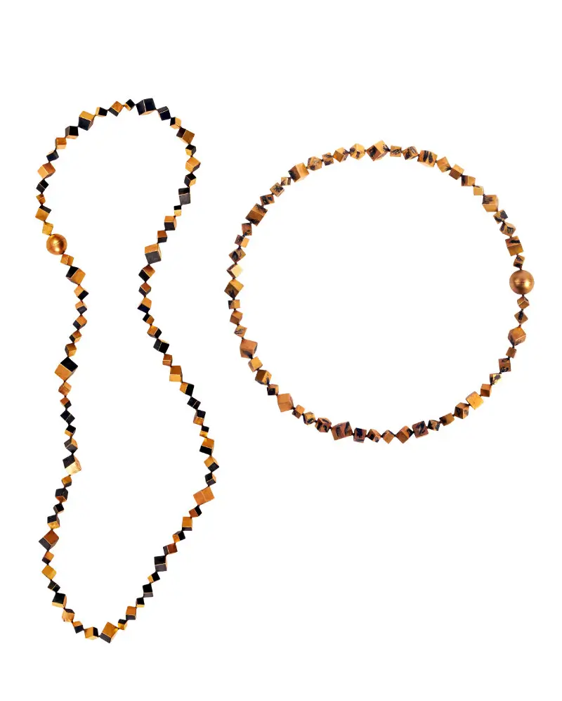 Intricate gold necklaces by Graziano Visintin featuring angular geometric links and dark niello detailing, created for the 2026 LOEWE FOUNDATION Craft Prize special mention exhibition against a minimalist studio background