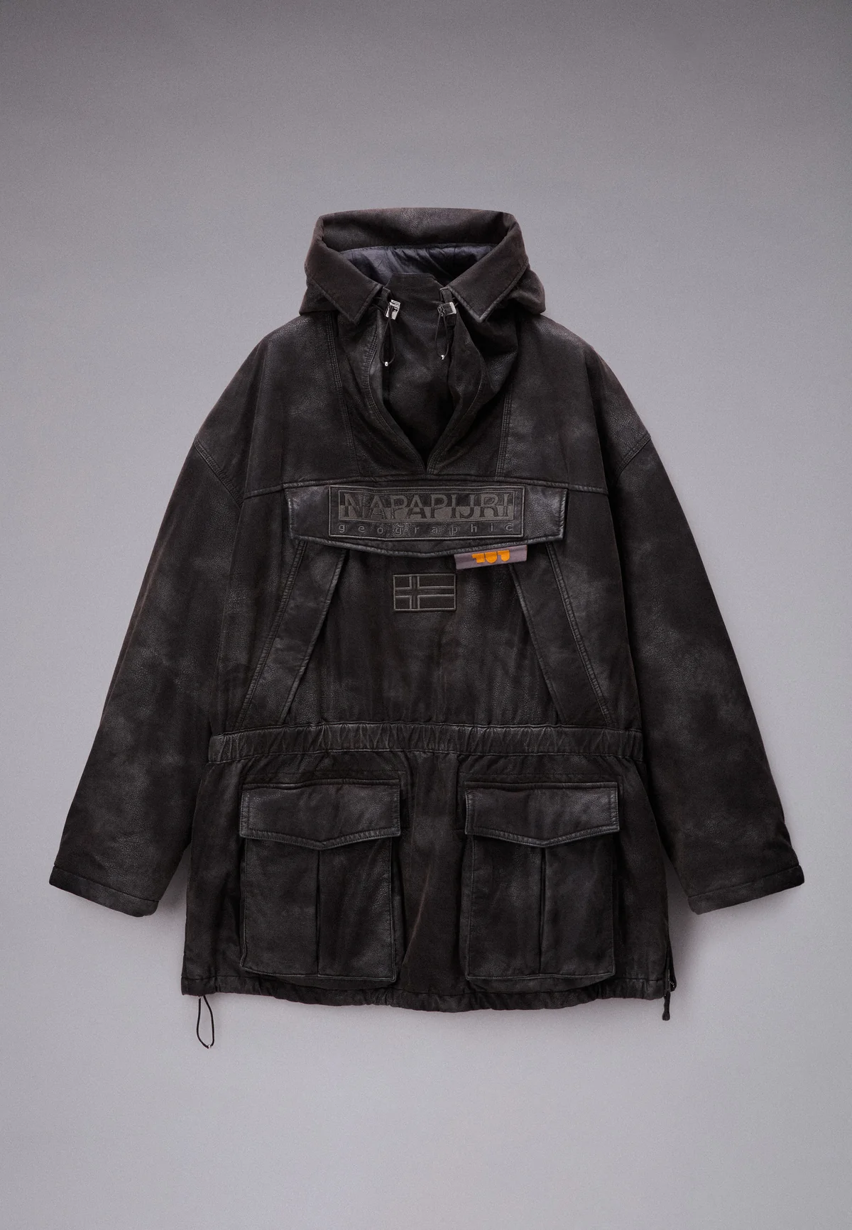 Black reimagined Napapijri anorak rendered in a weathered, armour-inspired finish with oversized utility pockets, sculptural hood construction, and cinematic outerwear styling