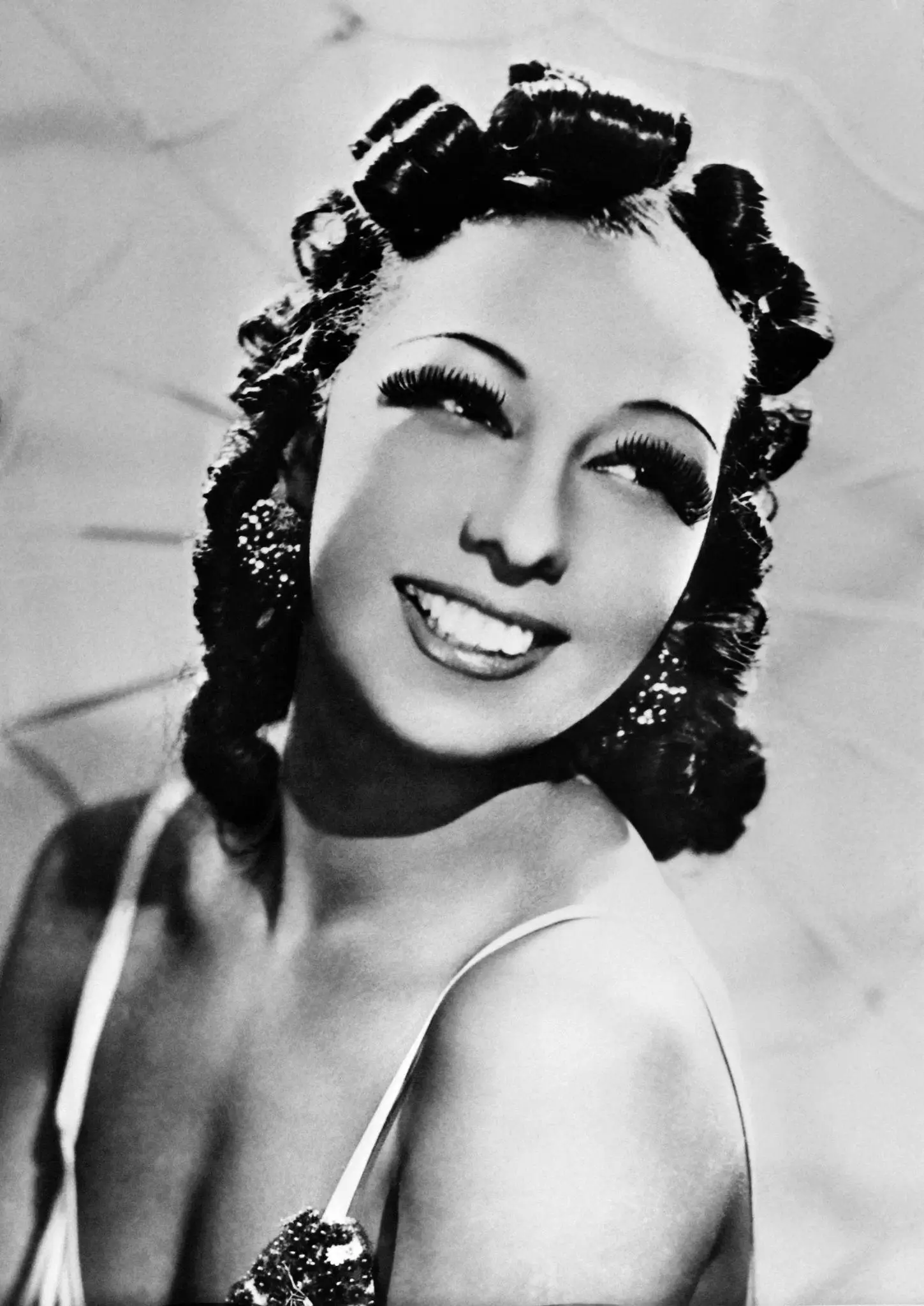 Black-and-white portrait of a glamorous vintage actress smiling softly over her shoulder, featuring sculpted pin curls, dramatic long lashes, sparkling statement earrings, and a satin embellished gown that reflects the elegance and cinematic allure of Hollywood’s golden age
