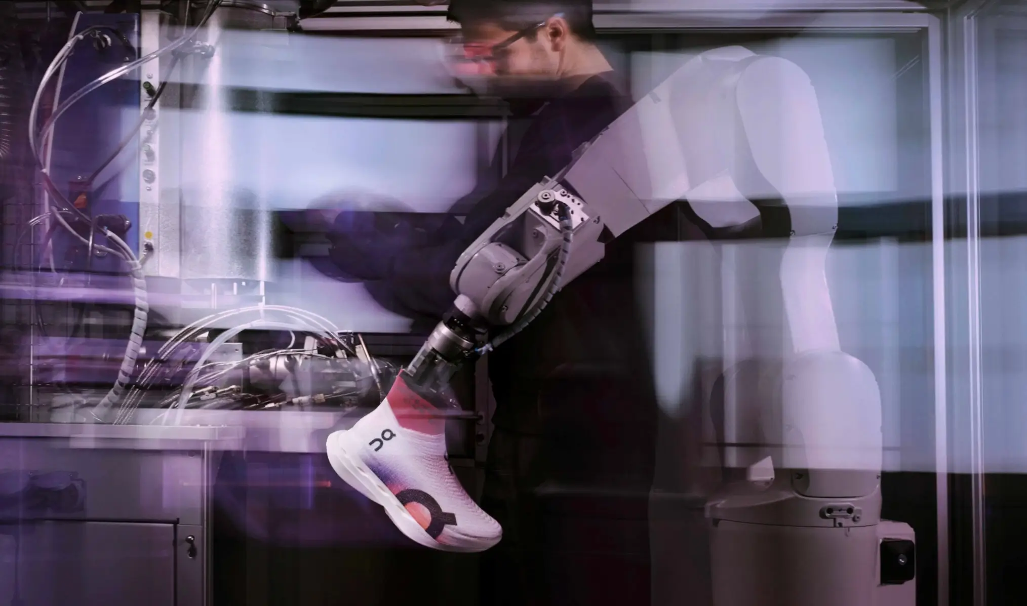 Robotic arm in a lab environment holding a freshly produced On running shoe while a technician moves in the background, with motion blur emphasizing the speed and precision of the LightSpray manufacturing process
