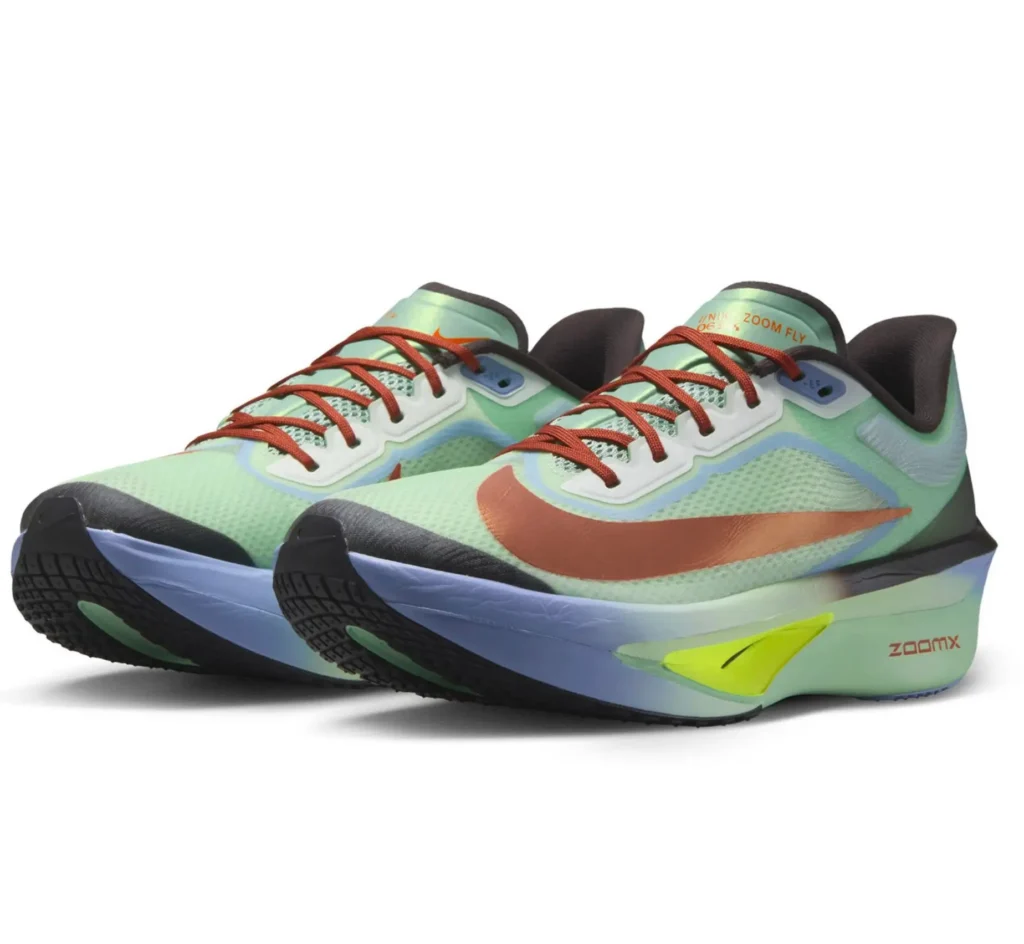 Angled pair shot of the Nike Zoom Fly 6 in mint green with metallic copper detailing, red laces, pale blue midsole accents, and a neon yellow Flyplate insert designed for speed-focused running