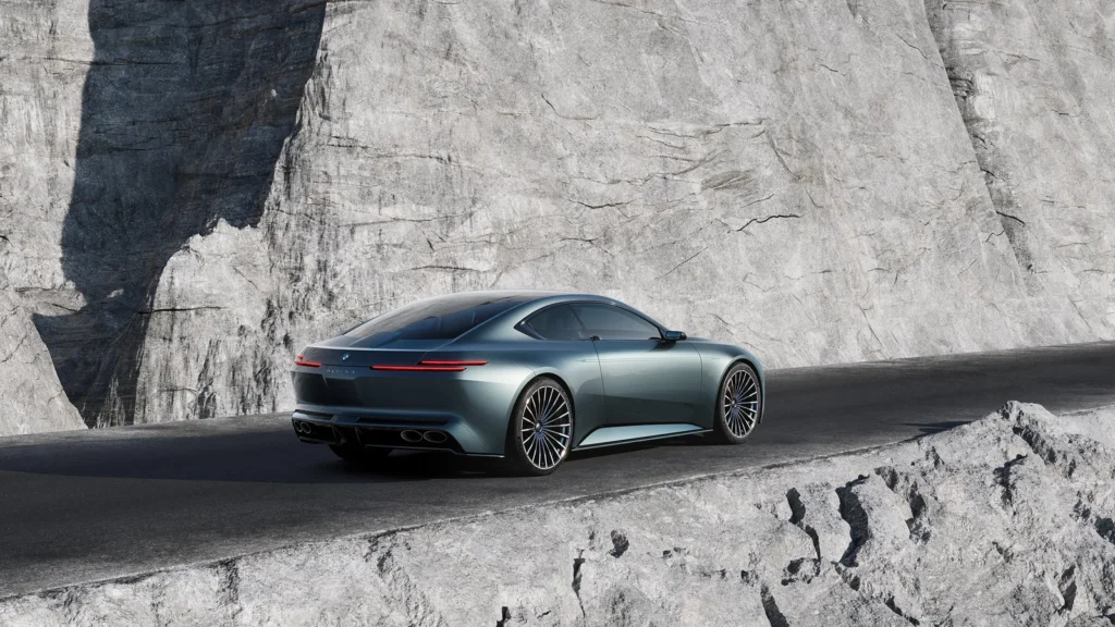 The Vision BMW ALPINA is captured from the rear three-quarter angle along a stark stone roadway, emphasizing the concept’s fusion of sculptural restraint and grand touring presence. Its sweeping fastback silhouette tapers elegantly into a minimalist rear fascia defined by ultra-thin horizontal taillights and discreet ALPINA badging, while the quad elliptical exhaust outlets subtly reference the marque’s performance heritage. The muted metallic bodywork reflects the surrounding quarry walls with near-liquid smoothness, allowing the environment to become part of the design language itself. Oversized multi-spoke wheels, low-slung proportions, and the uninterrupted shoulder line reinforce the coupe’s sense of effortless motion, presenting the car less as an aggressive super GT and more as a refined luxury instrument engineered for vast continental journeys