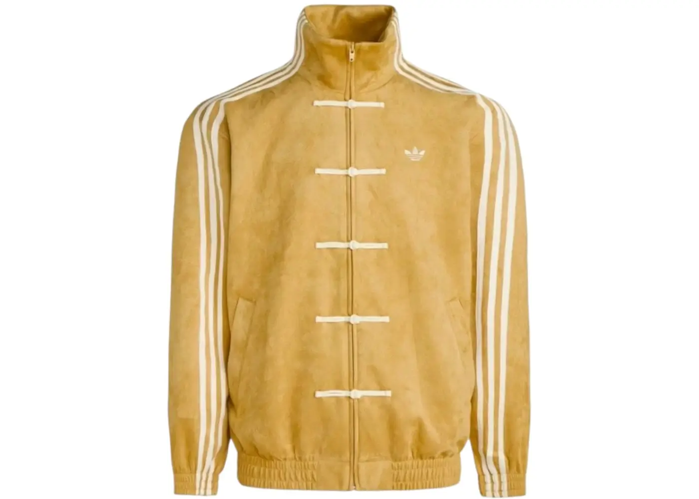 The adidas Originals CTT Chinese Track Top is also presented in a warm oat colorway that softens the silhouette’s structured design through a lighter, vintage-inspired palette. Cream Three Stripes and matching frog-button closures complement the jacket’s muted suede-like texture, allowing the Tangzhuang references to feel understated rather than overtly decorative. The oversized fit, ribbed hem, and minimal Trefoil branding reinforce the piece’s versatility, positioning it comfortably between football-inspired outerwear, lifestyle fashion, and modern East-meets-West styling