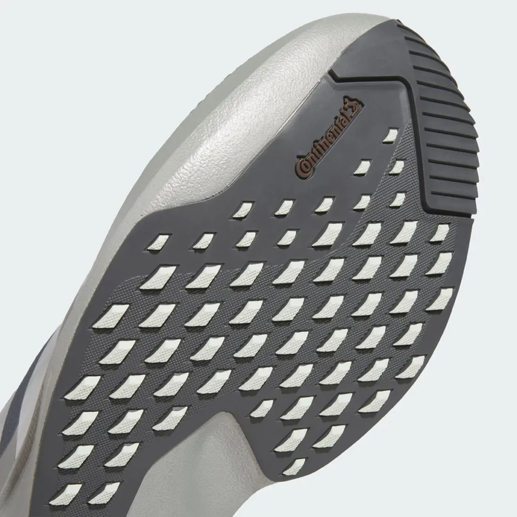 Close-up outsole view of the adidas Star Wars Mandalorian & Grogu Adizero EVO SL ATR highlighting the rugged Continental rubber traction system, geometric lug layout, and exposed Lightstrike Pro foam beneath the grey all-terrain running platform