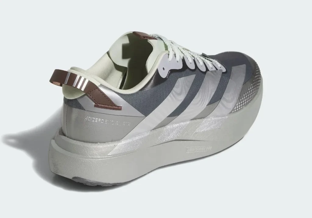 Rear three-quarter view of the adidas Star Wars Mandalorian & Grogu Adizero EVO SL ATR showcasing the ripstop upper, reflective Three Stripes overlays, rugged heel construction, and muted beskar-inspired grey palette with subtle Grogu green interior accents