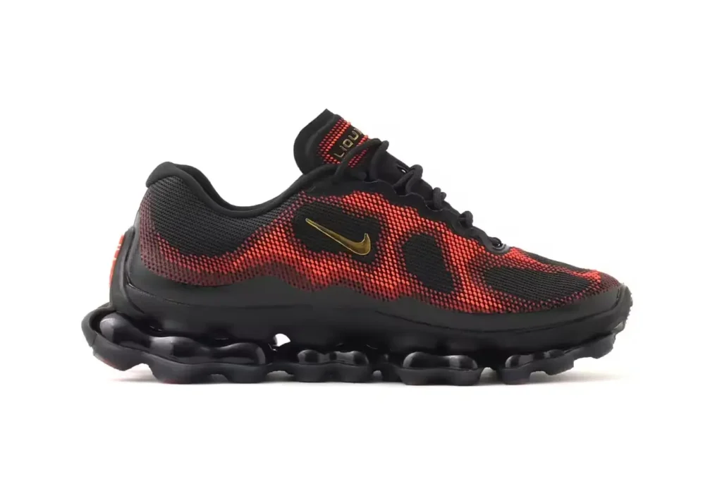 Clean lateral product shot of the Nike Air Liquid Max emphasizing the layered liquid-effect mesh texture, metallic gold Swoosh detailing, and futuristic Air-driven sole geo