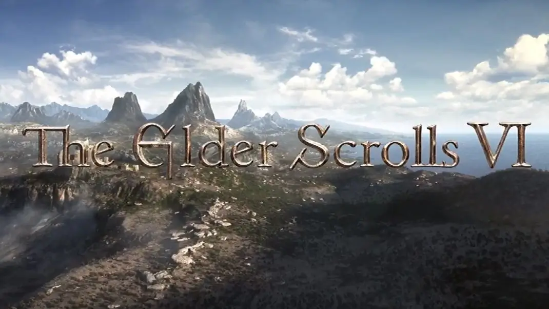 Official teaser image for The Elder Scrolls VI featuring a sweeping cinematic landscape of rugged mountain peaks, rocky cliffs, and distant coastline beneath a bright sky with scattered clouds, overlaid with the metallic title logo across the center
