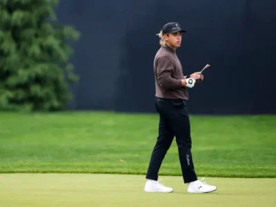 Garrick Higgo walks the fairway at Aronimink during Round 1 of the 2026 PGA Championship. Despite a two-stroke penalty for arriving one minute late to his tee time, the laid-back South African fired a resilient 1-under 69. Classic “Higgo time” — but still in the mix