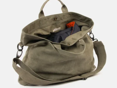 Finlay Vincent Helmut Bag #19 crafted from upcycled military tent fabric, featuring an olive canvas exterior, spacious padded interior, dual carry handles, adjustable shoulder strap, and rugged utility-inspired design