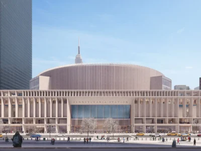 Street-level architectural rendering of a reimagined Pennsylvania Station façade in Midtown Manhattan, featuring a monumental colonnaded exterior and curved upper structure framed by surrounding towers, with pedestrians, yellow taxis, and the Empire State Building rising in the background