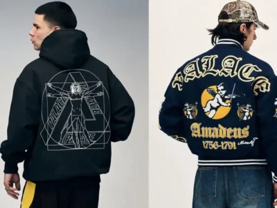 Split editorial lookbook image from Palace Summer 2026 showcasing two back-facing statement pieces: on the left, a black oversized hoodie featuring a large Vitruvian Man-inspired Palace graphic layered with geometric Tri-Ferg outlines; on the right, a navy “Amadeus” varsity jacket covered in ornate collegiate embroidery, cherub artwork, gothic lettering, and classical Mozart references, styled with denim and a Realtree camouflage cap