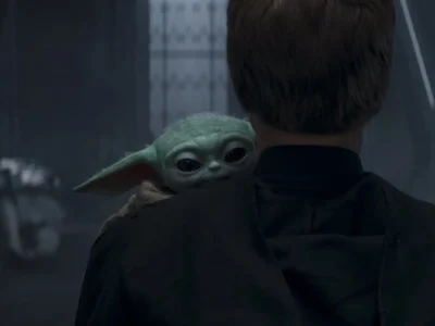 Grogu peers over the shoulder of a cloaked Jedi figure inside a dimly lit futuristic corridor, his large reflective eyes fixed toward the viewer while soft blue lighting and blurred armored figures create a tense, cinematic atmosphere reminiscent of the evolving emotional stakes within the modern Star Wars universe