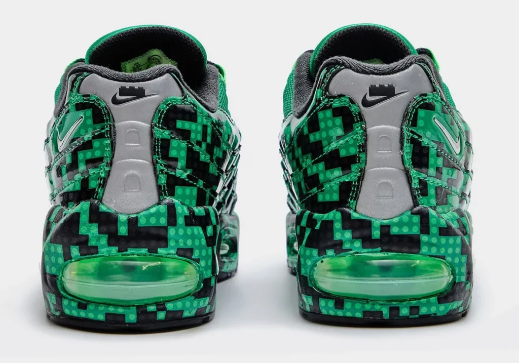 Rear view of the LEGO x Nike Air Max 95 “Lucky Green” featuring reflective grey heel tabs, embossed Nike branding, brick-inspired green-and-black print wrapping the heel, and translucent green Air cushion