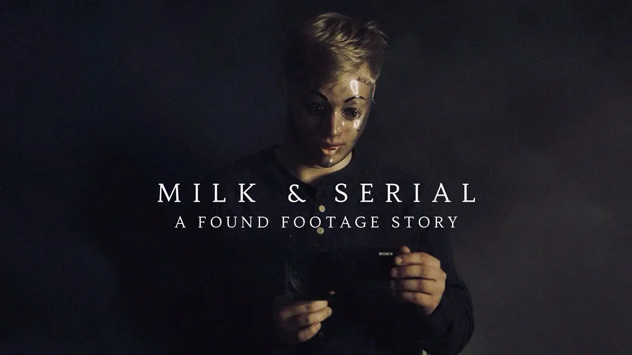 Dark minimalist poster for Milk & Serial: A Found Footage Story showing a person wearing a pale mannequin mask while holding a camera in dim lighting, with the film title displayed in large white serif typography against a silhouette black background
