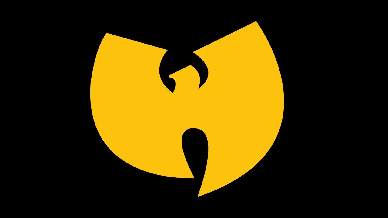 Close-up of the iconic Wu-Tang Clan logo rendered in solid golden yellow against a black background. The emblem features the group’s signature stylized “W” mark with sharp, wing-like curves and a symmetrical silhouette, creating a bold, instantly recognizable graphic associated with hip-hop culture, martial arts influences, and the collective’s visual identity