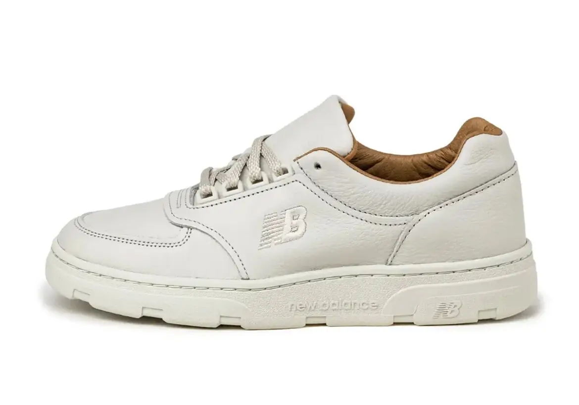 Side-profile product shot of the New Balance Allerdale shoe in Vaporous Grey and Chipmunk, featuring premium off-white leather uppers, tonal embroidered “NB” branding, textured cream sole tooling, and a rich tan leather interior against a clean neutral backdrop