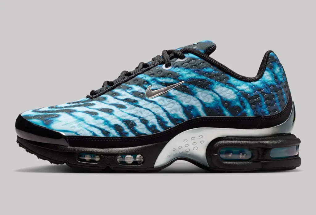 Nike Air Max Plus VII “Scorpion” shoe in black with electric blue, wave-like upper pattern, textured synthetic surface, silver Swoosh, black laces, and visible Tuned Air cushioning units along the midsole