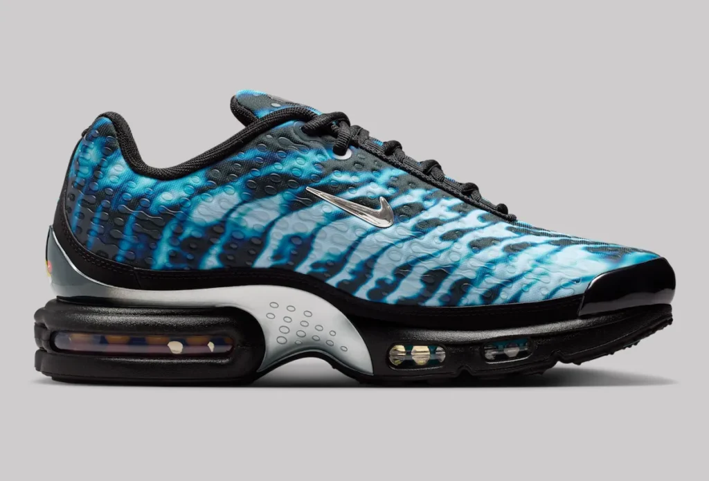 Side profile of Nike Air Max Plus VII “Scorpion” shoe in black with electric blue wave-patterned upper, textured dotted overlay, metallic silver Swoosh, and visible Tuned Air cushioning units along the midsole