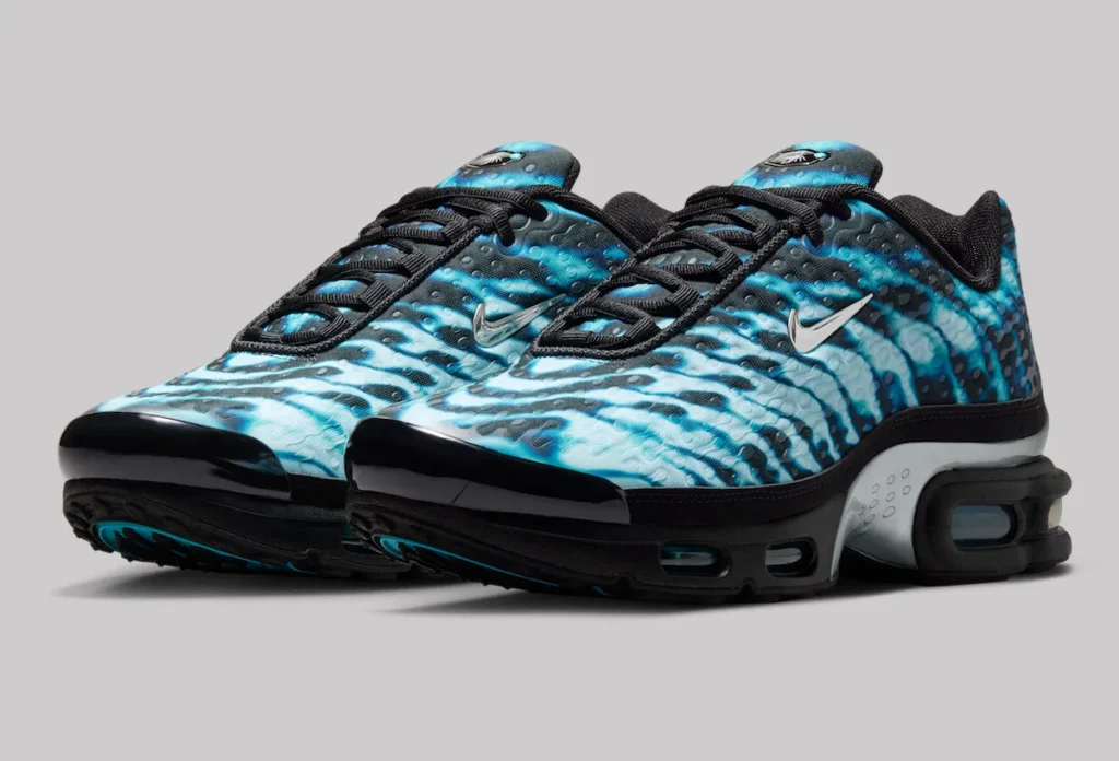 Pair of Nike Air Max Plus VII “Scorpion” shoe in black with electric blue wave-patterned uppers, featuring textured dotted overlays, metallic silver Swooshes, black laces, and visible Tuned Air cushioning along the midsole
