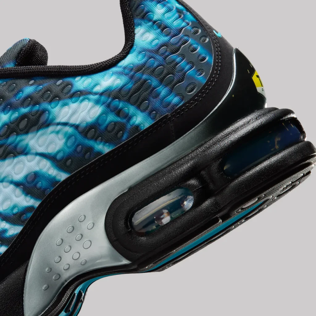 Close-up of Nike Air Max Plus VII “Scorpion” heel section showing black midsole with visible Tuned Air unit, translucent cushioning chamber, and blue gradient upper with textured, wave-like and dotted pattern detailing
