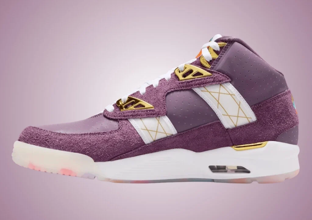 Nike Air Trainer SC “Atlanta Olympics” 30th Anniversary in Pro Purple featuring one side profile shoe shaggy suede overlays, metallic gold hardware, white mesh panels, embroidered peach branding, and a translucent multicolor outsole inspired by the 1996 Atlanta Olympic Games