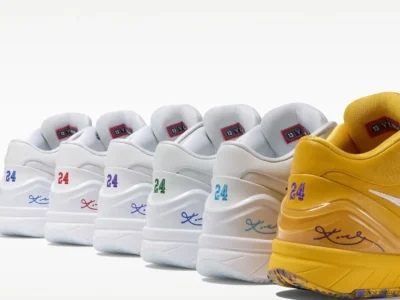 Rear view of multiple Nike Kobe basketball sneakers lined diagonally in alternating white and yellow colorways, each featuring embroidered “24” heel numbering, Kobe signature detailing, and color-accented branding inspired by different team palettes