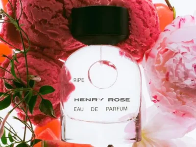 Henry Rose Ripe Eau de Parfum bottle surrounded by pink peonies, watermelon-inspired accents, and vibrant summer florals
