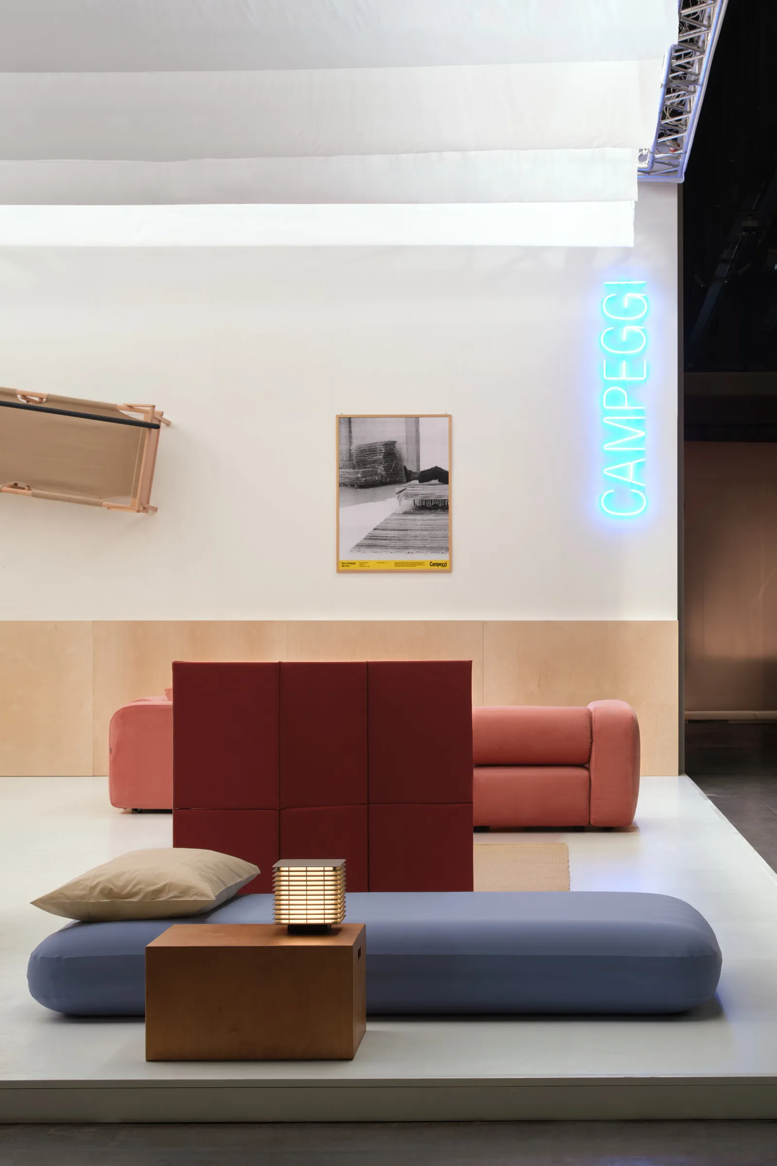 Campeggi exhibition installation featuring modular guest room furniture, inflatable bedding, and minimalist contemporary interiors at Salone del Mobile 2026