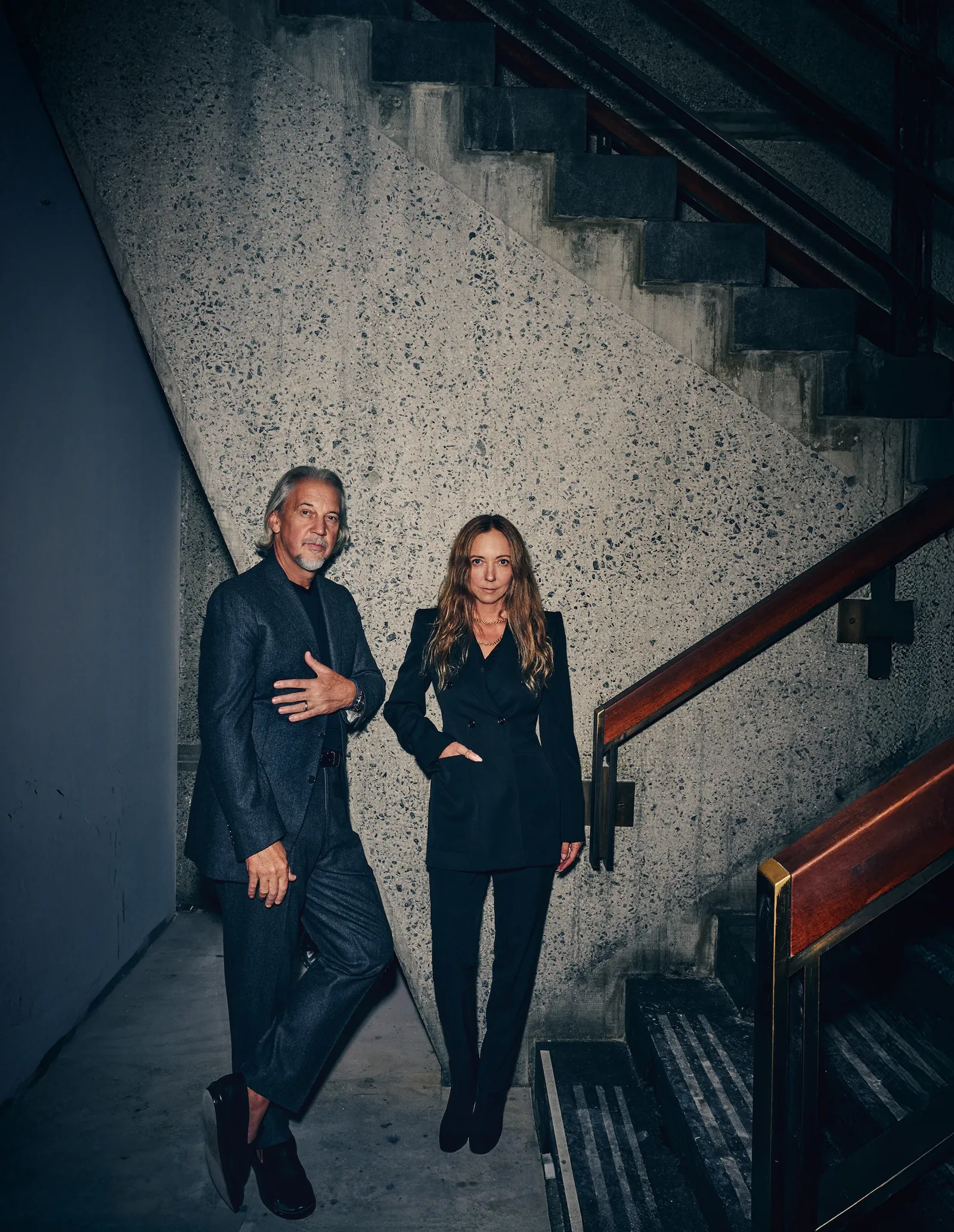 Two designers pose beside the Breuer Building’s monumental concrete staircase, reflecting the architectural heritage behind Marcel at Sotheby’s