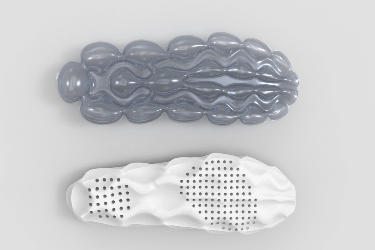 Top-down comparison of an experimental Nike Air cushioning prototype and sculpted foam component, highlighting the organic chamber geometry, pressure-mapped perforations, and fluid design language that informed the development of the Air Liquid Max platform