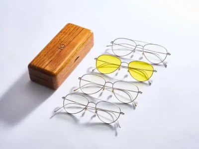 white background, including aviator and rounded silhouettes with one pair featuring bold yellow-tinted lens