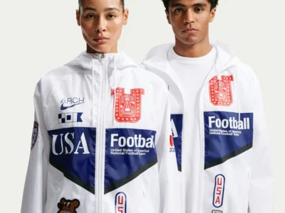 Male and female models wearing matching America Football rugby polos with oversized typography, patriotic striping, and retro team-inspired detail