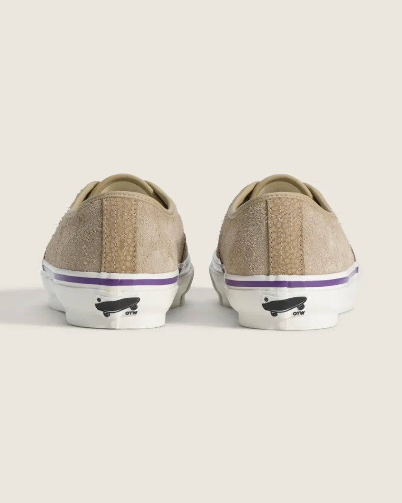Rear view of the beige Vans OTW Authentic 44 Siped Vibram displaying premium suede heel panels, purple foxing stripe accents, and signature OTW skateboard branding on the heel tabs