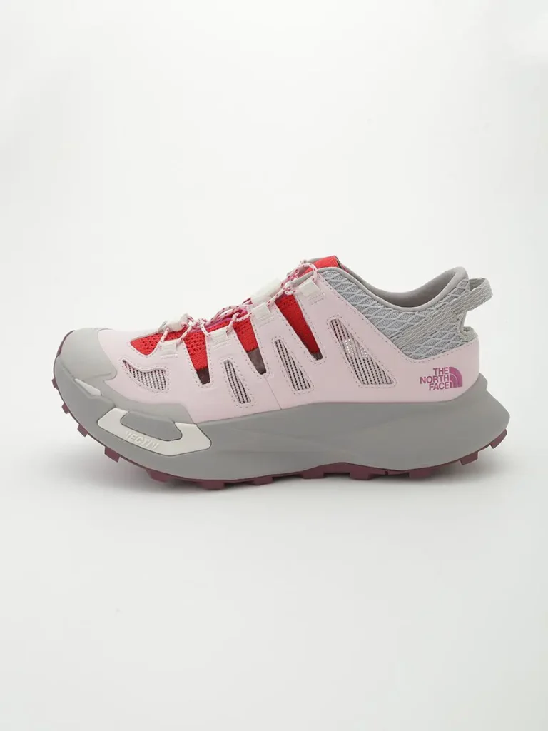 Lateral profile of The North Face VECTIV Breeze in pastel pink and grey with coral accents, built for lightweight hiking and trail exploration