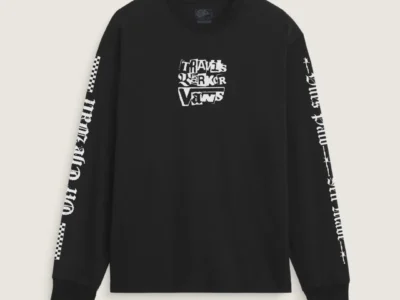 Black long-sleeve Travis Barker x Vans shirt featuring bold collaborative branding on the chest and gothic graphics running down both sleeve