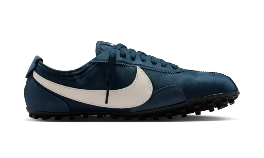 Opposite side profile of the navy blue shoe showcasing the oversized white Swoosh, sleek nylon upper, and textured black outsole