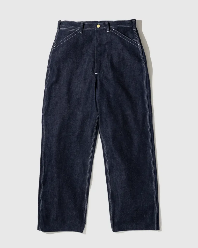 Front view of the Lee Archives 11-W waistband overalls in raw indigo denim with a straight-leg silhouette, button fly, reinforced seams, belt loops, and contrast white stitch
