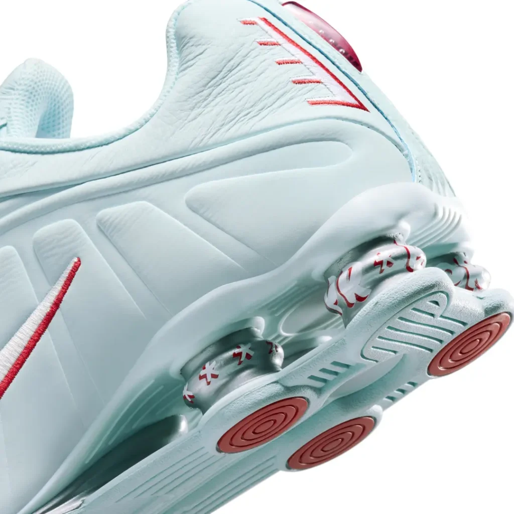 Detailed rear-quarter view of the Nike Shox R4 Light Aqua featuring metallic Shox columns with red graphics and molded heel support