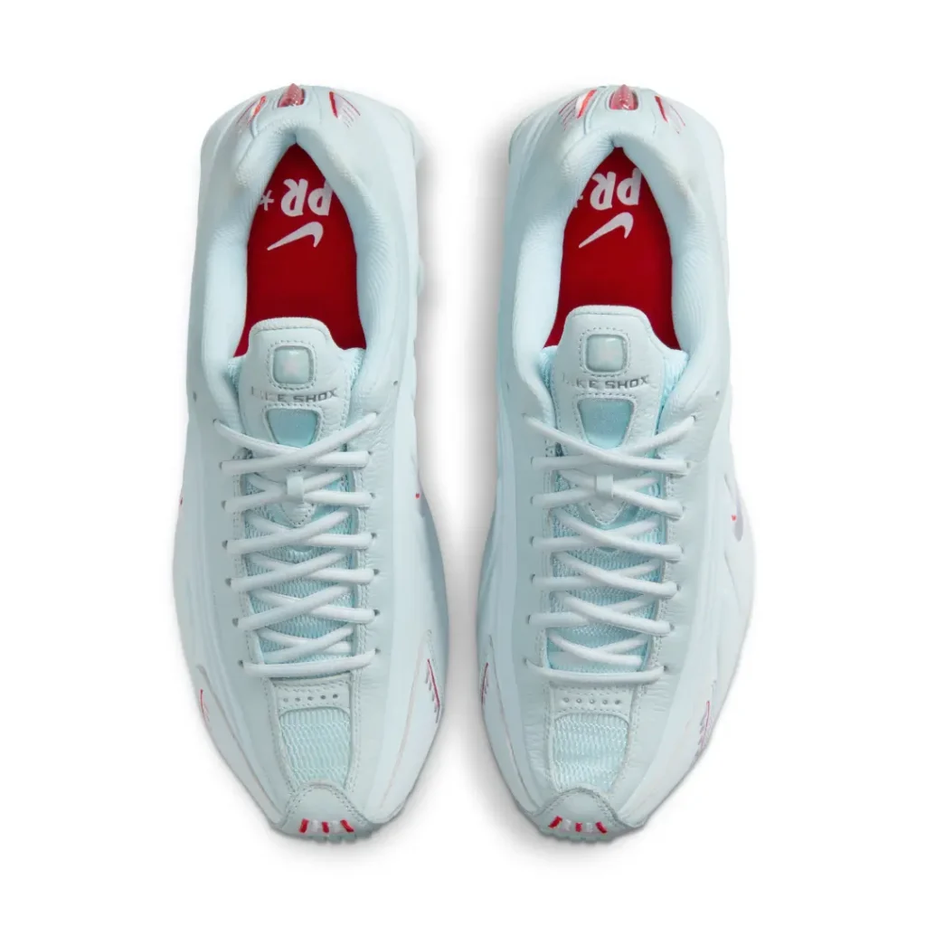 Top-down view of the Nike Shox R4 Light Aqua highlighting padded collars, mesh tongues, white laces, and vibrant red sockliner