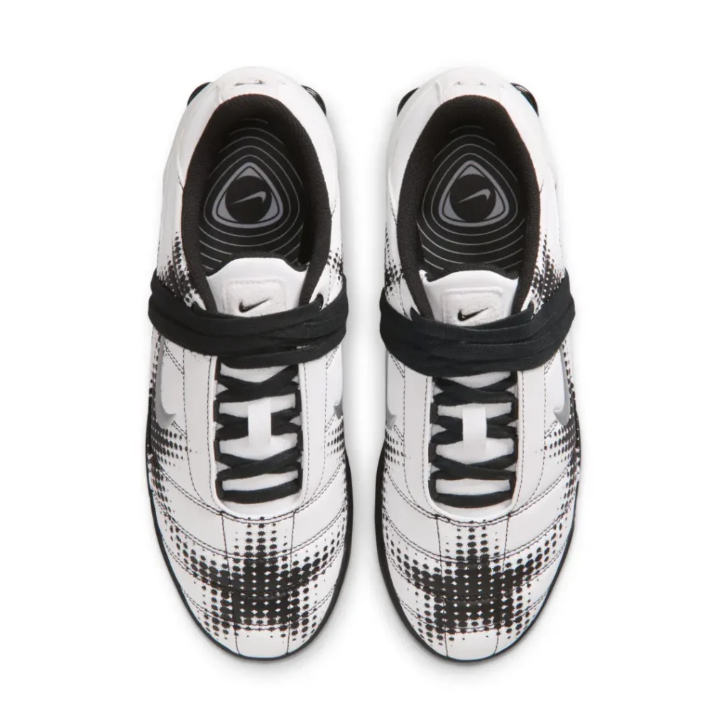Top-down view of the white and black colorway revealing oversized wraparound laces, padded interior lining, and branded graphic insole
