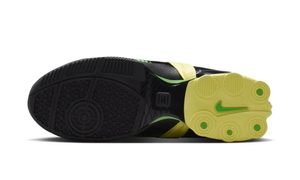 Outsole view of the green colorway highlighting a two-tone traction pattern, circular grip zones, and a contrasting green Nike Swoosh underfoot