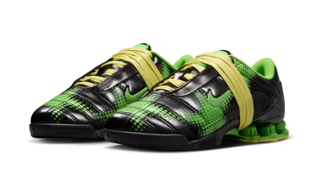 Angled product shot of the green and black shoe pair highlighting the bold plaid-inspired graphic treatment and distinctive Shox sole unit
