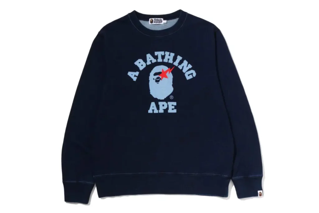 Navy A BATHING APE crewneck sweatshirt featuring the signature ape-head logo and bold varsity-style brand