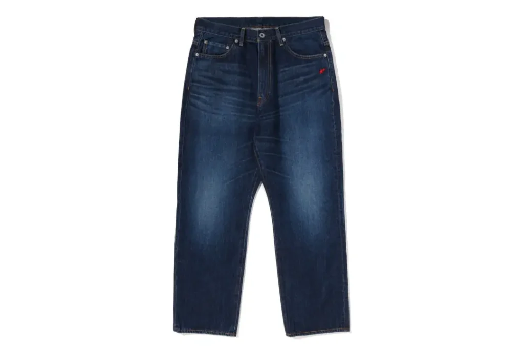 Vintage-wash A BATHING APE denim jeans featuring relaxed straight-leg construction and subtle red embroidered accent