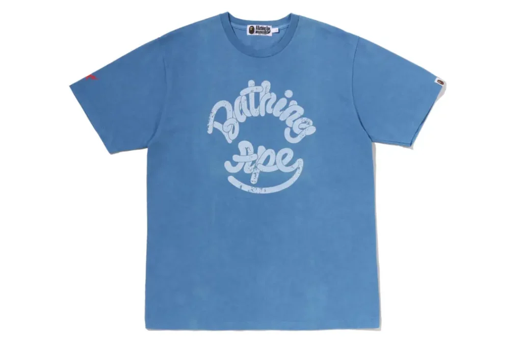 Light blue A BATHING APE T-shirt showcasing a vintage-inspired Bathing Ape script logo across the chest