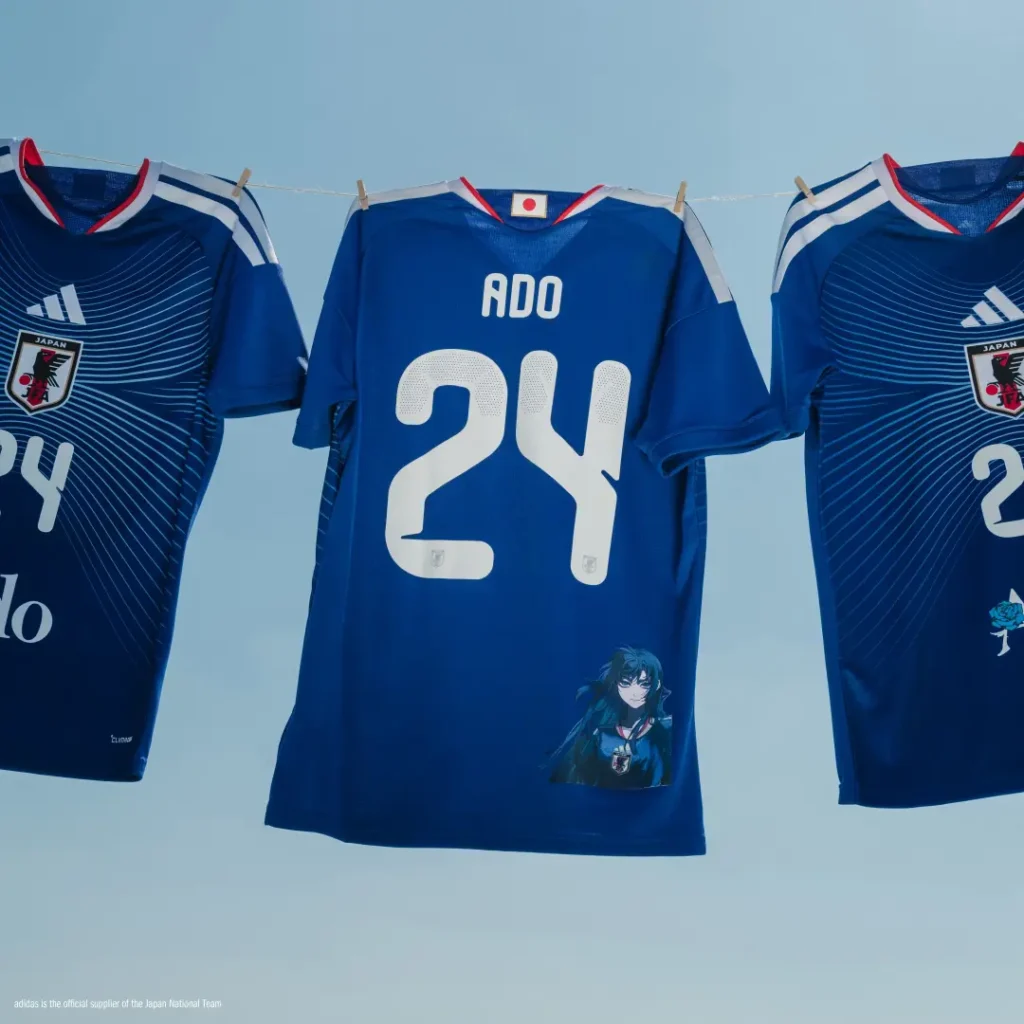 Back view of the Ado x Japan national team jersey showcasing the name ADO, oversized number 24, and anime character graphic near the lower hem