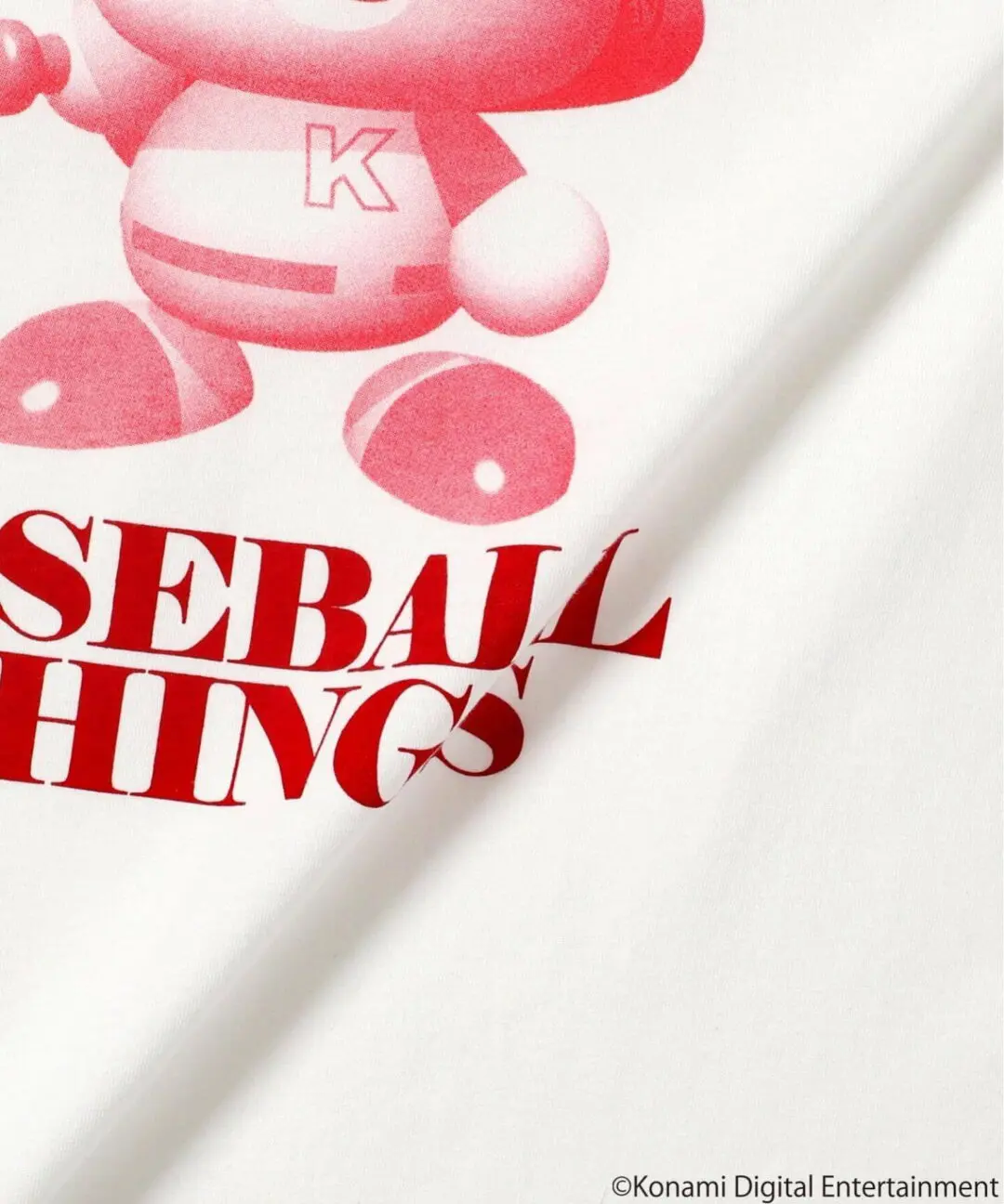 Fabric detail of the Baseball Things T-shirt highlighting smooth cotton texture, vibrant pink mascot print, and bold red typography element
