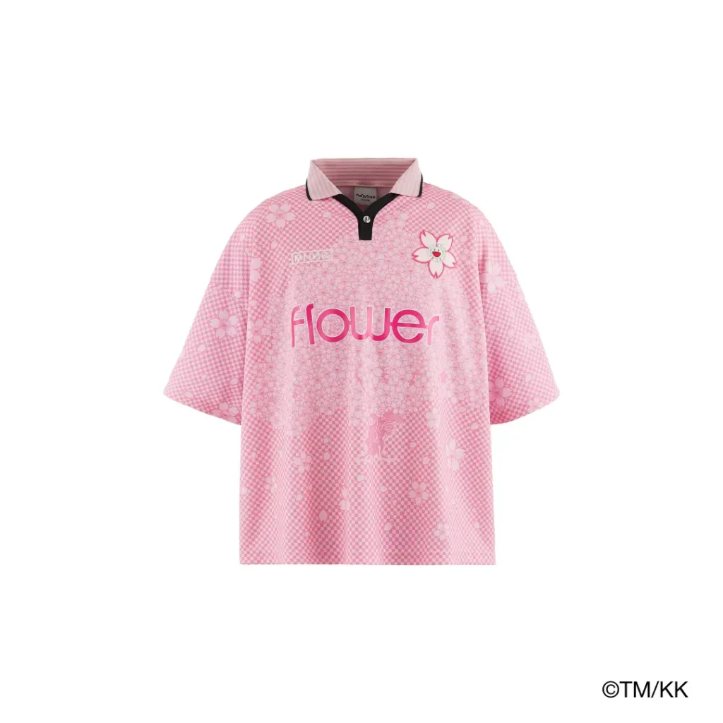 Front product image of a pink oversized polo shirt featuring floral motifs, checkerboard-inspired patterns, and prominent “Flower” branding. The design combines sporty and play view influence