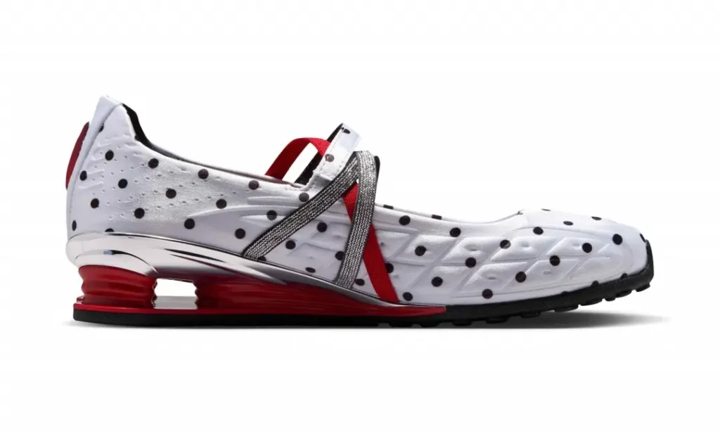 Opposite side view of the Nike Shox Mary Jane featuring a quilted white upper with black polka dots, metallic silver straps crossing the midfoot, and a red Shox heel unit paired with chrome detail