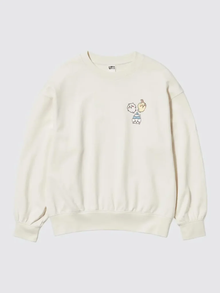 Cream-colored UNIQLO UT Chiikawa crewneck sweatshirt featuring a small embroidered trio of Chiikawa, Hachiware, and Usagi on the left chest